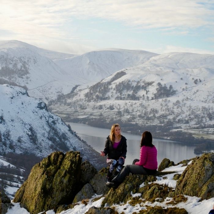 Dr Katie on Hallin Fell talking to a friend in the snow